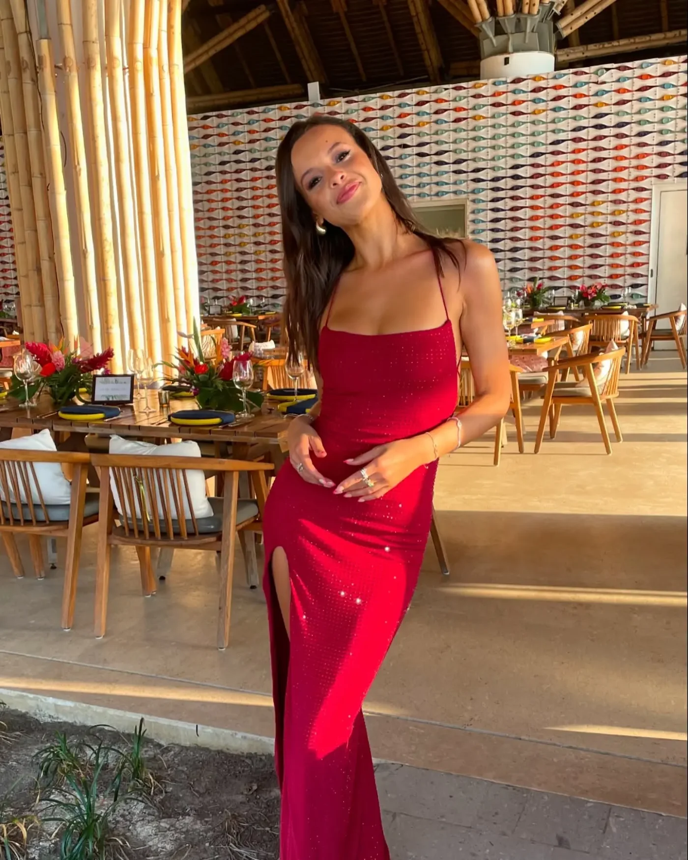 Aubrey Cleland smiling in a red sparkly dress at a restaurant.