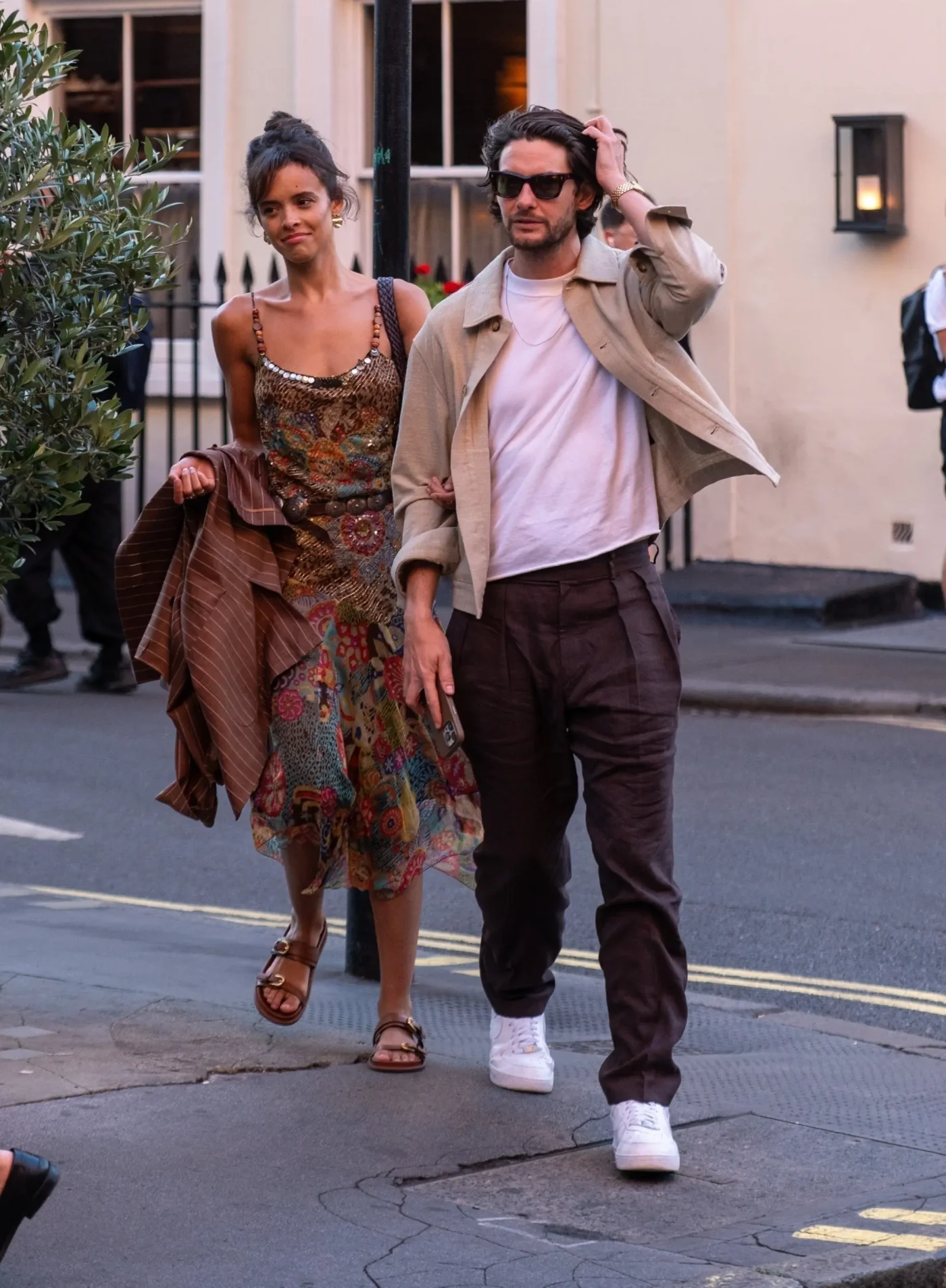 Ben Barnes and Aubrey Cleland walking together, arm in arm, after dinner in London.