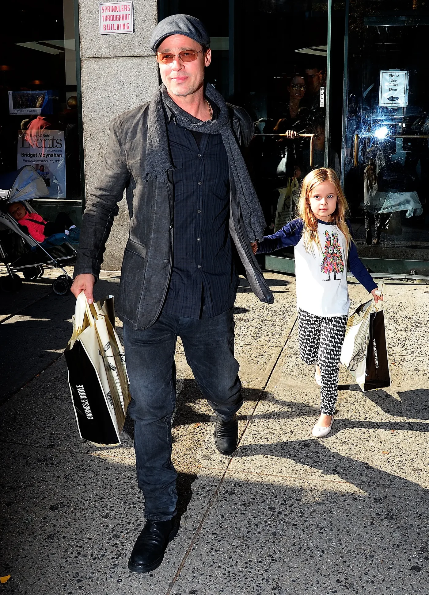 Brad Pitt holding hands with Vivienne Jolie-Pitt outside Barnes & Noble.