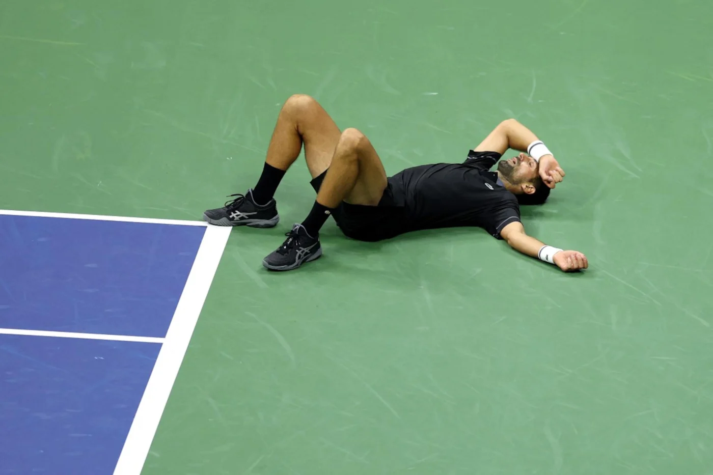NEW YORK NEW YORK - AUGUST 30: Novak Djokovic of Serbia falls against Mariano Navone of Argentina during their Men