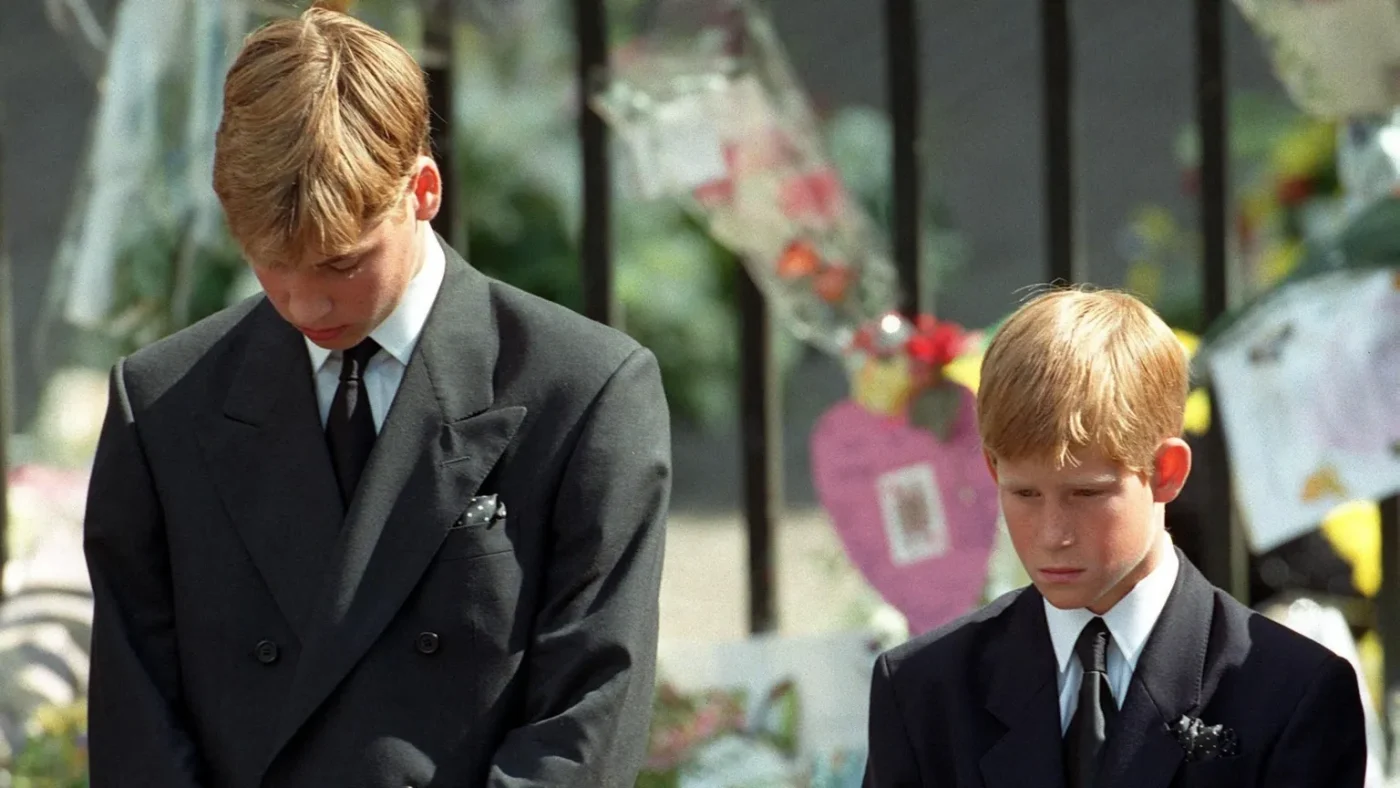 PA Media Prince William and Prince Harry bow their heads as their mother
