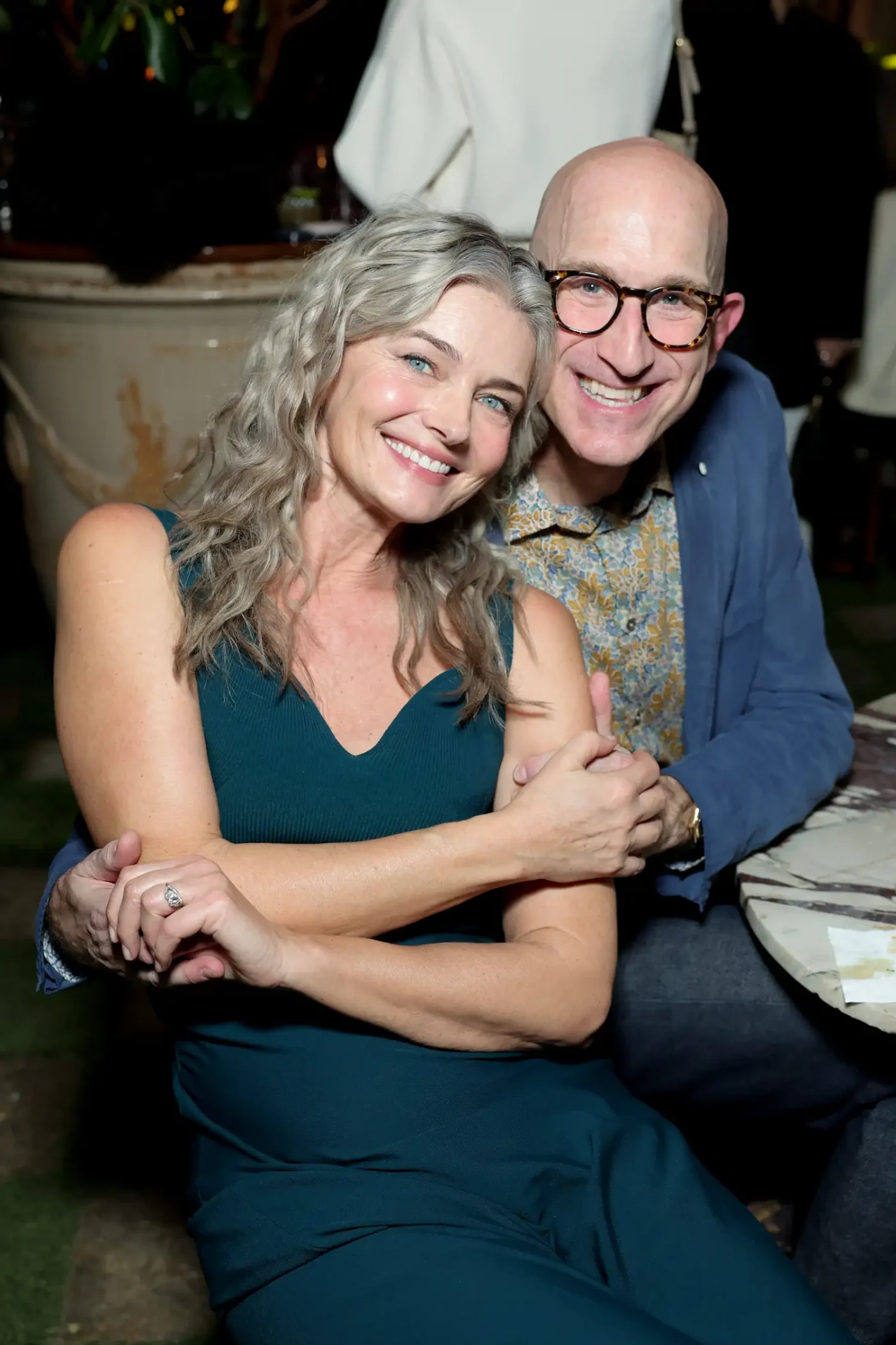 Paulina Polizkova and Jeff Greenstein hugging at an event