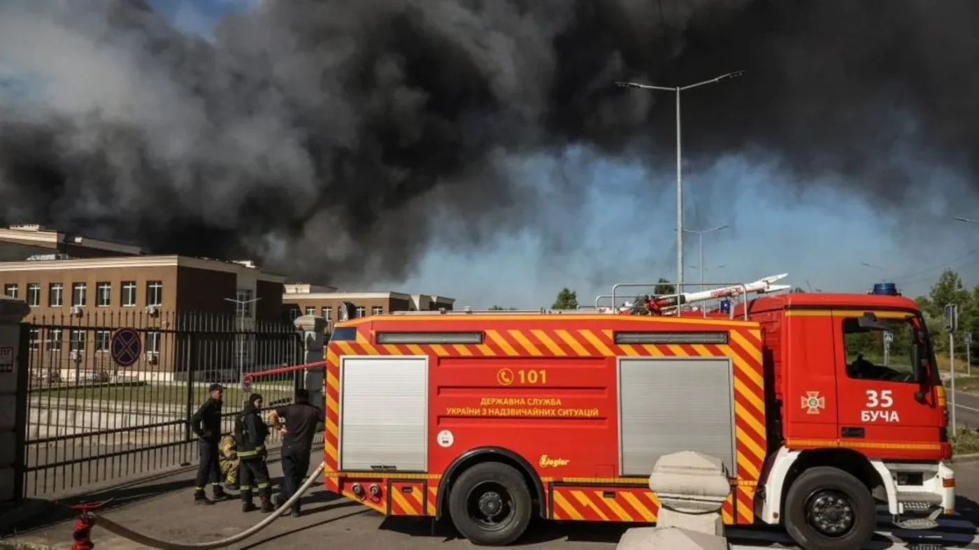 Firefighters work at the site of a Russian drone strike as smoke rises, amid Russia's attack on Ukraine, in Kyiv region, Ukraine