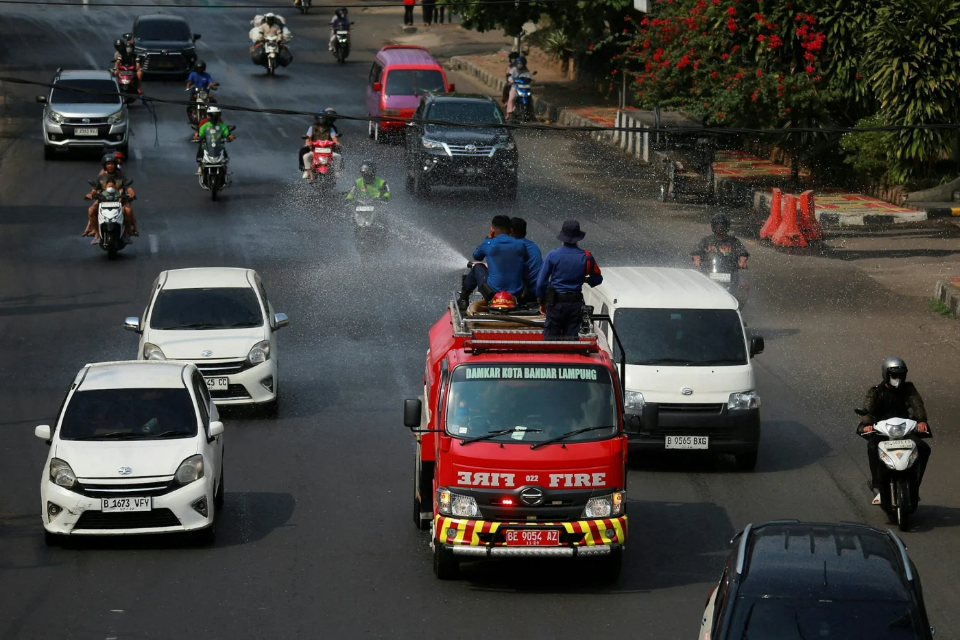 In Bandar Lampung, Indonesien, befeuchtet die Feuerwehr die mit Vulkanasche bedeckten Straßen.