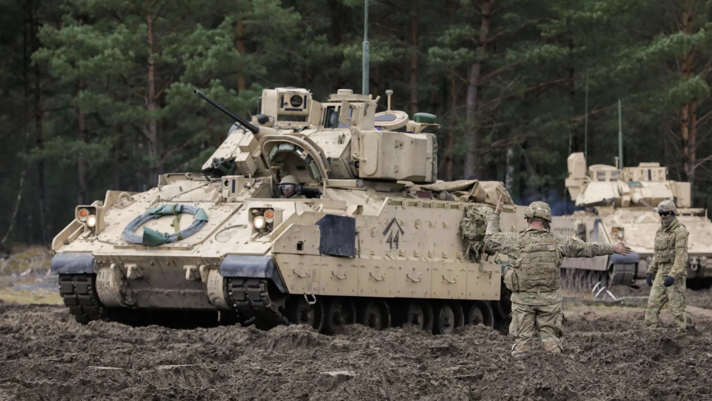 RECORD DATE NOT STATED A U.S. Soldier assigned to the 1st Squadron, 4th Cavalry Regiment, 1st Armored Brigade Combat Team, 1st Infantry Division gives directions to an M2 Bradley Infantry Fighting Vehicle at Trzebien, Poland, Feb. 22, 2022. The 1-4 Cav conducted the Table V gunnery table, which trains the tank crew to engage stationary and moving targets, placed in tactical arrays, from a stationary and moving tank with tank-mounted automatic weapons in both day and night scenarios. Copyright: xpiemagsx dvi